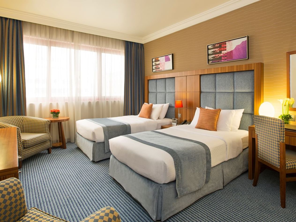 2 Beds & lounge area in Deluxe Room at City Seasons Hotels