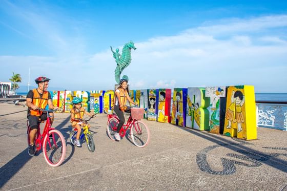 Family cycling near the beach at Buenaventura Grand Hotel