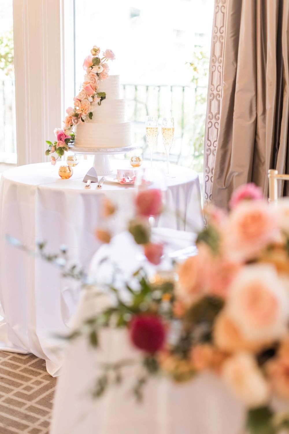 Beautifully decorated multi-tiered wedding cake with floral accents at El Prado Hotel
