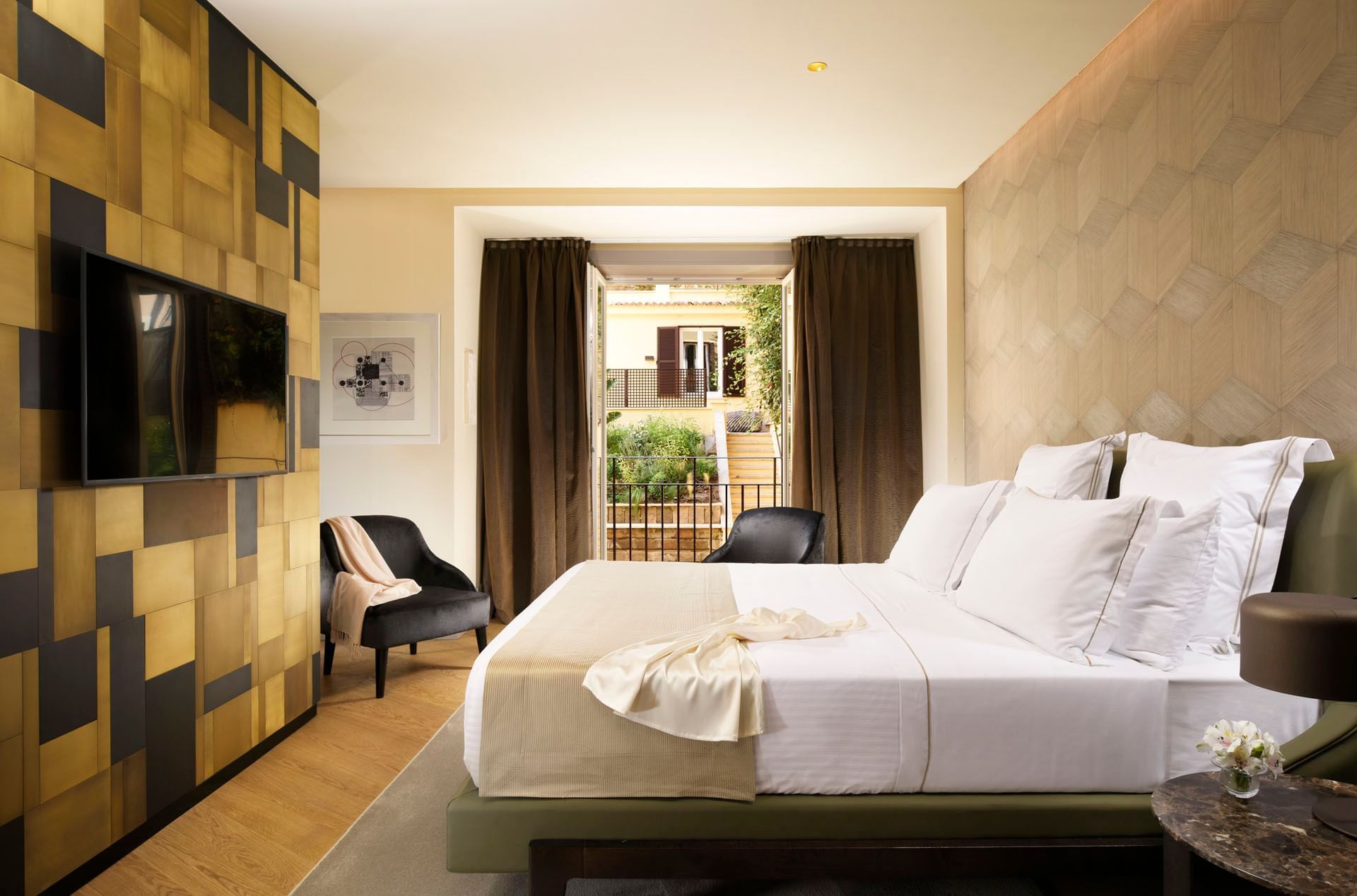 Double bed and seating with an outdoor view in Deluxe Suite at Margutta 19