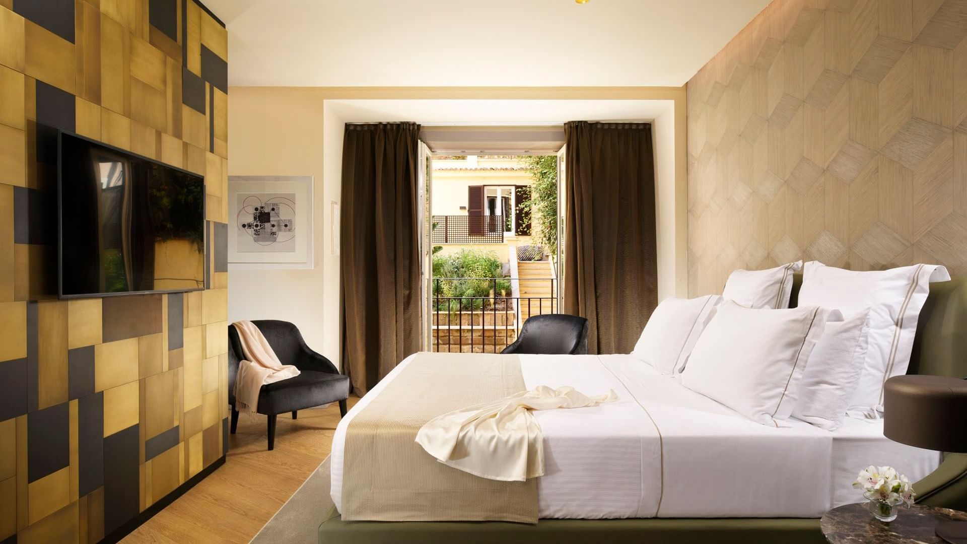 Double bed and seating with an outdoor view in Deluxe Suite at Margutta 19