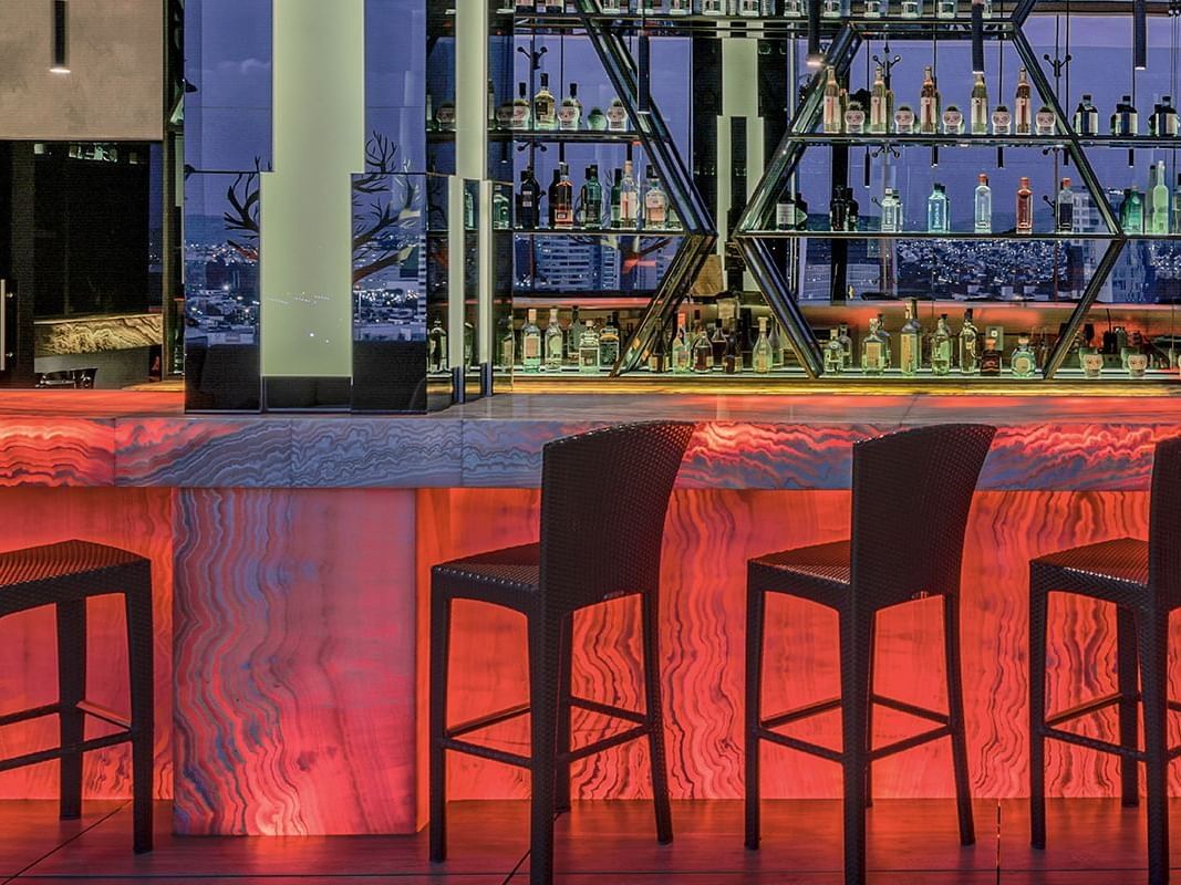 Bar counter with high chairs in Sky bar at La Colección Resorts