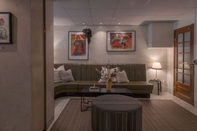 Lobby lounge area with carpeted floors & art hung on the walls at The Sparrow Hotel