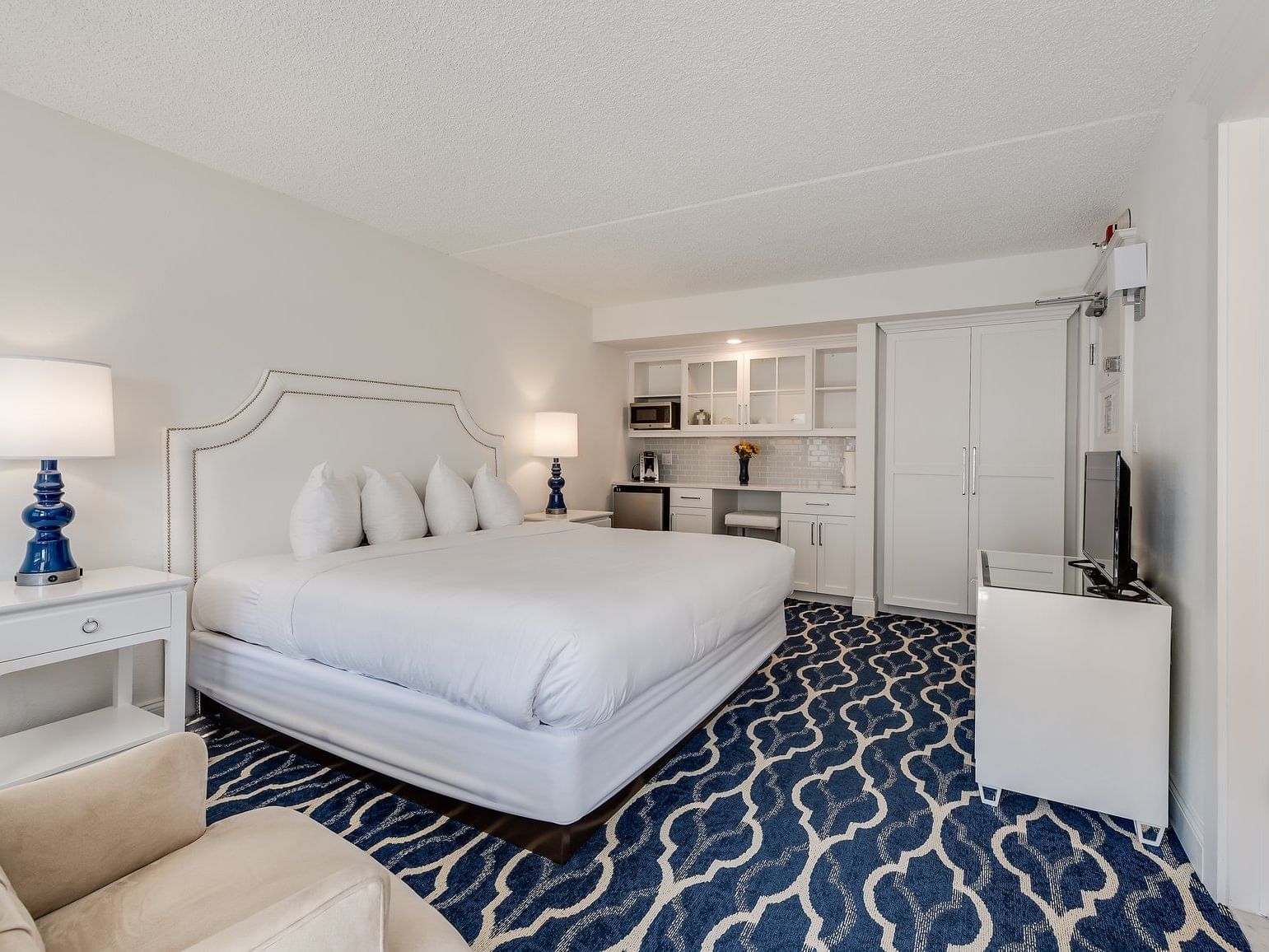 King bed and small kitchen area in Premium King Cape May hotel room