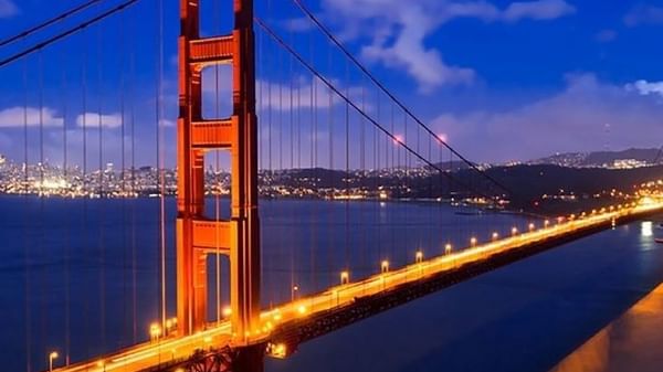 Golden Gate Bridge by city lights under a night sky near Warwick San Francisco