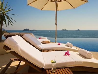 Comfy sun loungers by the infinity pool at Cala de Mar