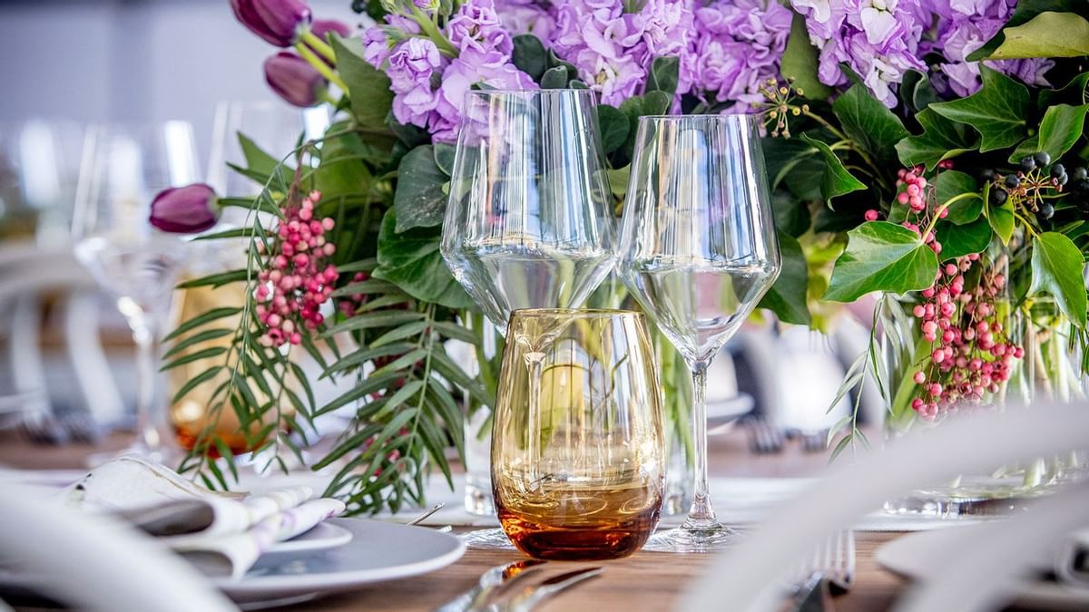 Close-up of glassware & flowers on a table at Crown Hotels