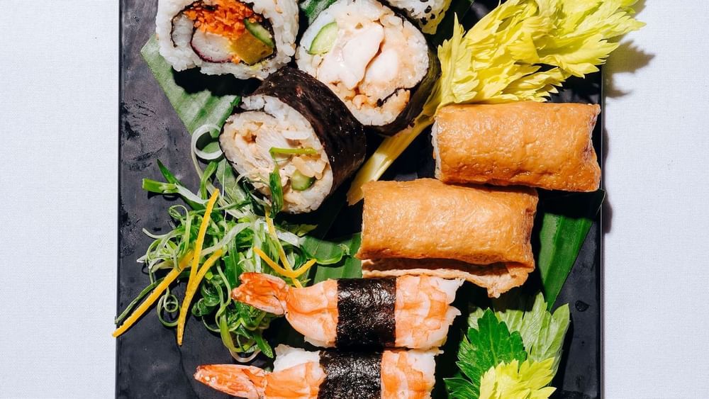 Vibrant sushi platter featuring various rolls, shrimp sushi, and inari served in Marine Room at Novotel Sydney Olympic Park