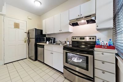 The kitchen with appliances in a guest room at Artmore Hotel