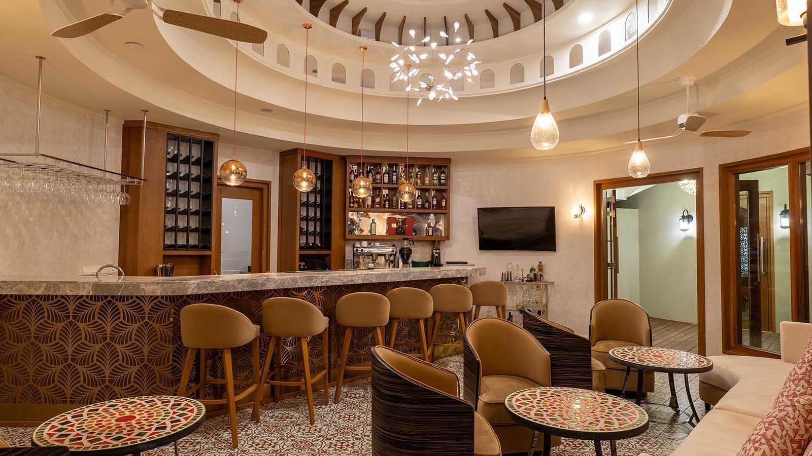 Bar stools by the bar counter at The Signature Collection