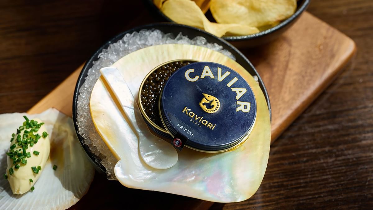 Tin of caviar on an oyster shell with ice in The Atlantic Restaurant at Crown Hotel Melbourne