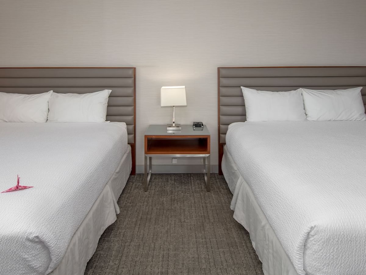 Two queen beds in a hotel suite.