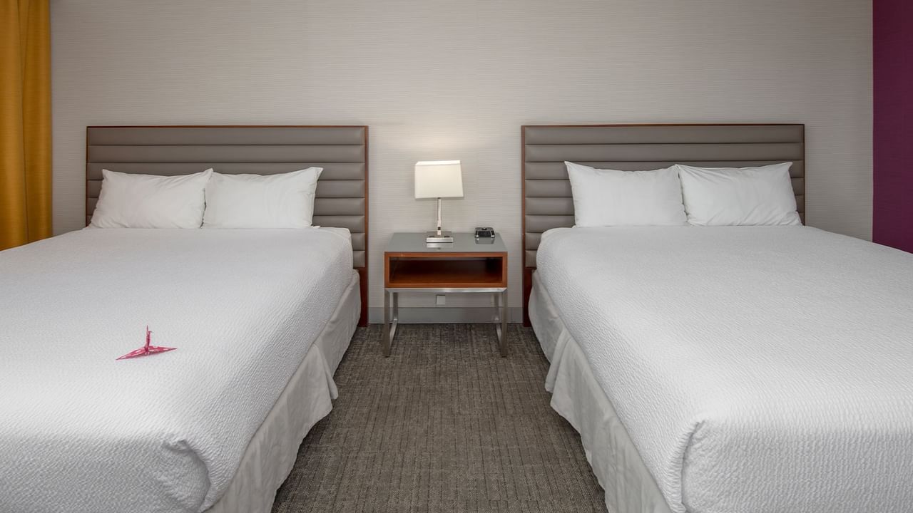 Two queen beds in a hotel suite.