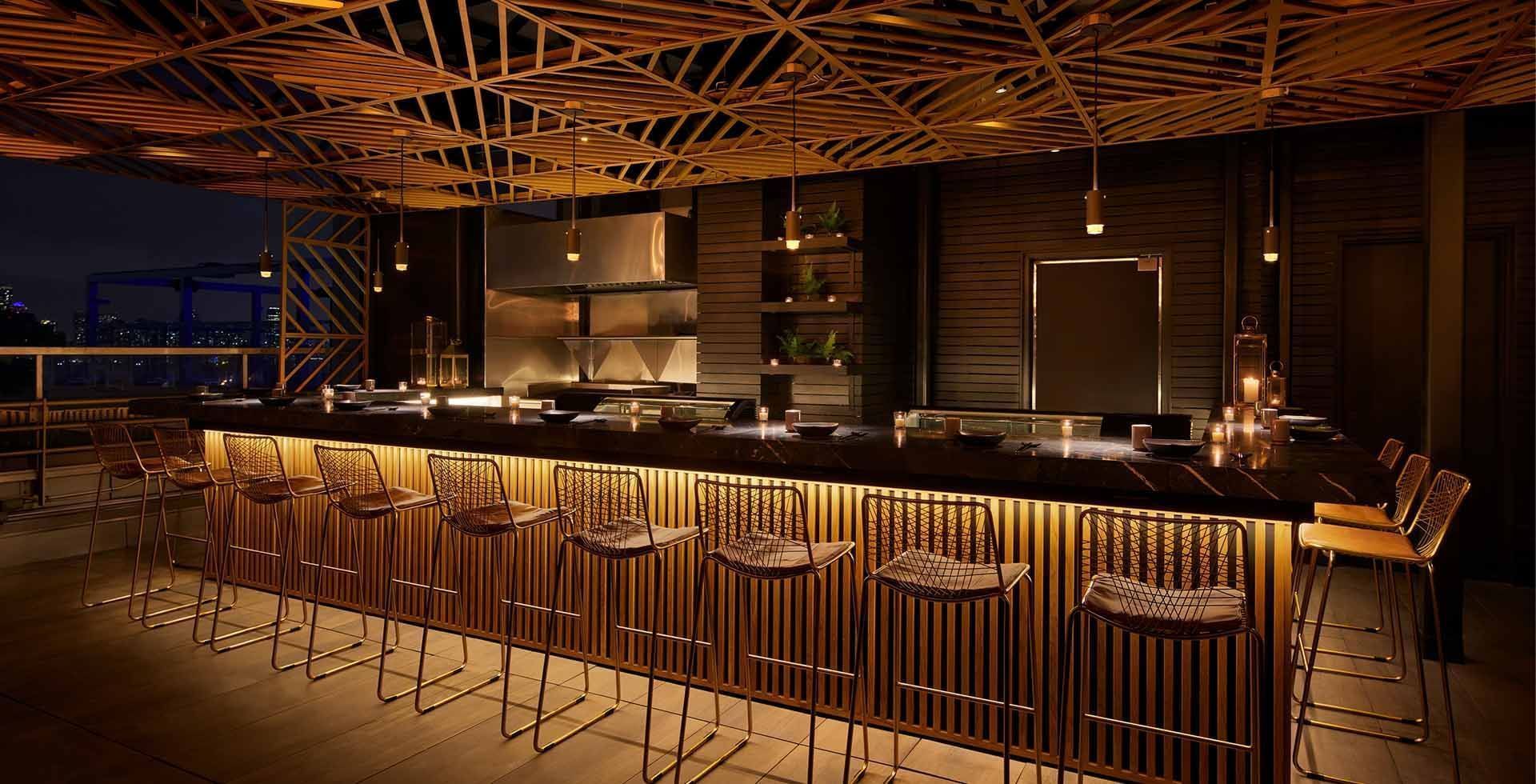 Saishin Omakase bar with stools and a wooden ceiling at Gansevoort Meatpacking NYC