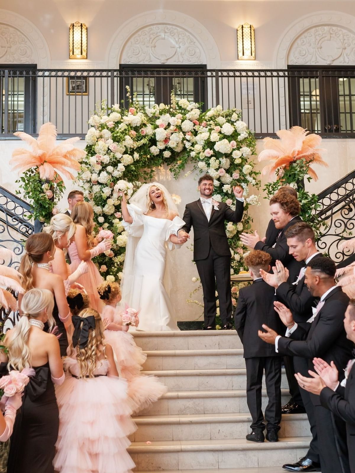 Bride & groom posing on stairway at The Mayo Hotel