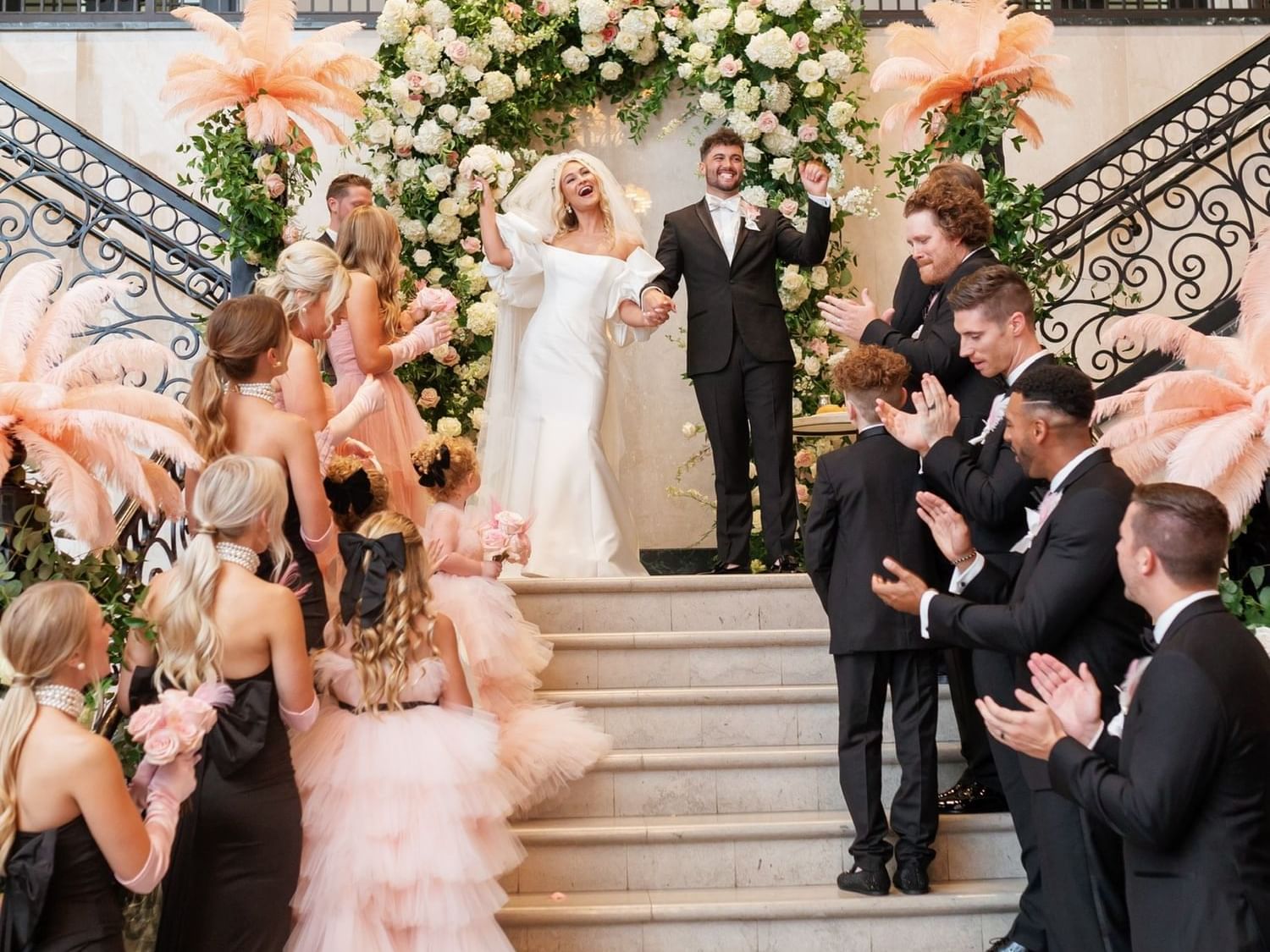 Bride & groom posing on stairway at The Mayo Hotel