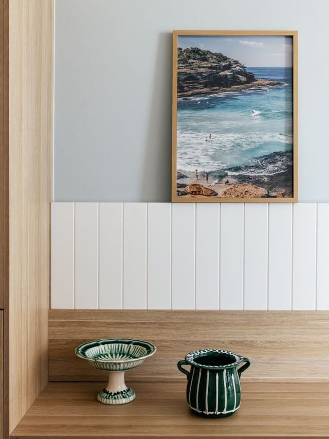 Ocean View Twin at Elysium Manly with framed ocean photography by a wooden wardrobe door under a soft blue paneled wall