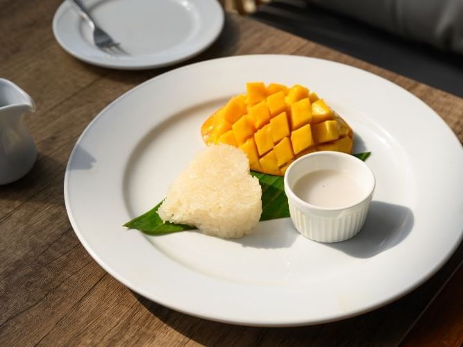 A plate of food on a table with Sticky rice with mango 