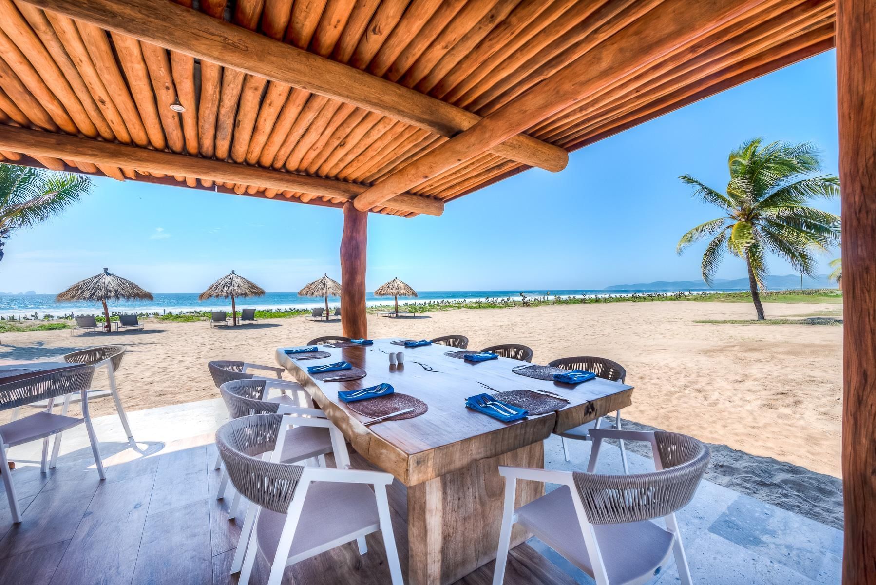 Outdoor dining area with a sea view at Marea Beachfront Villas
