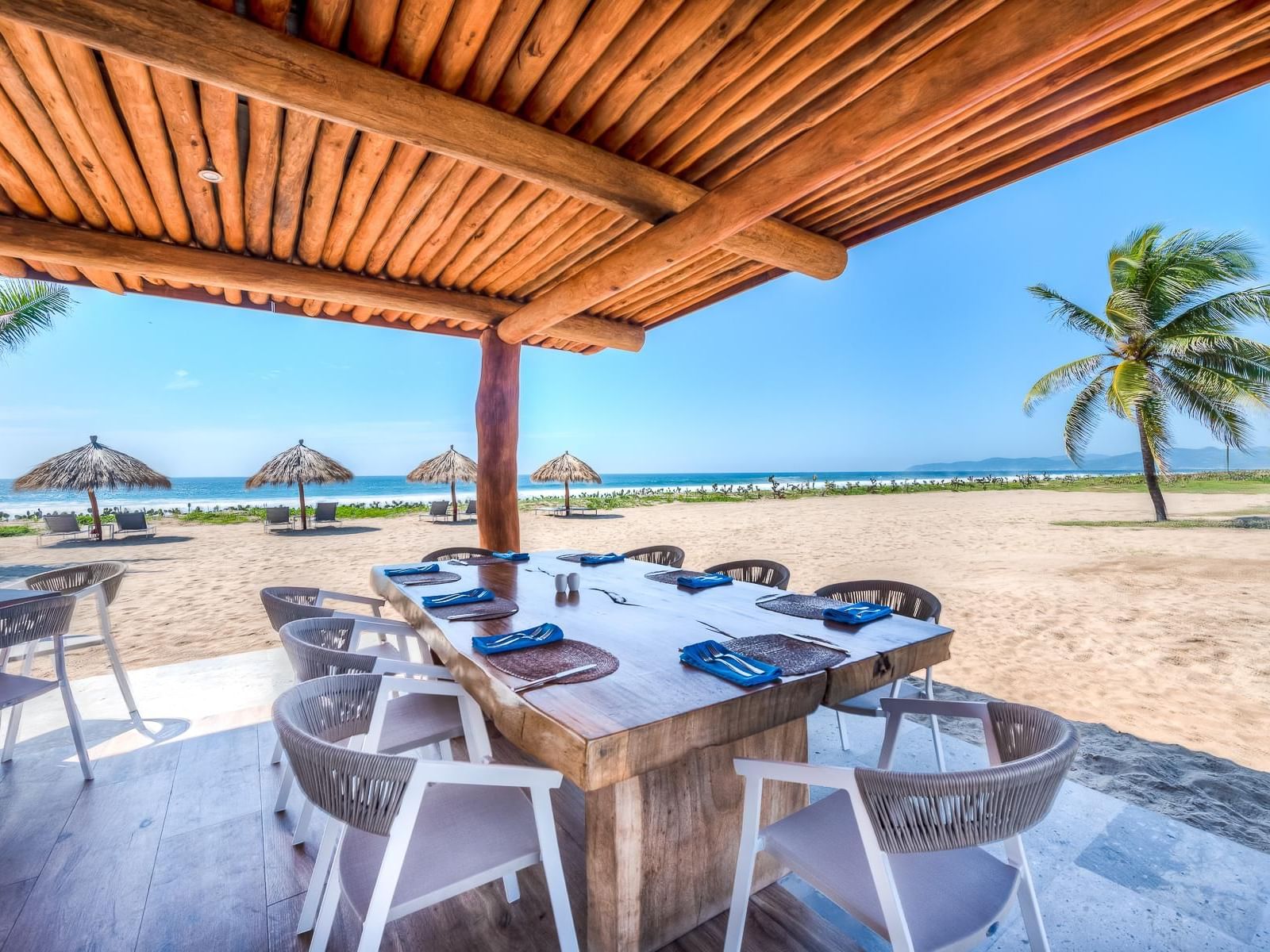 Ola outdoor dining area with sea view, Marea Beachfront Villas