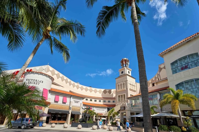 Aventura mall area with palm trees and various retail stores near The Diplomat Resort