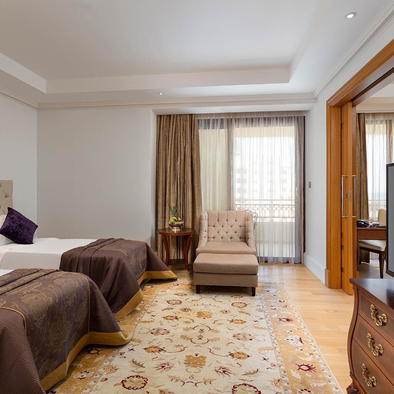 Two comfy beds and lounge in Family Room at Titanic Mardan Palace