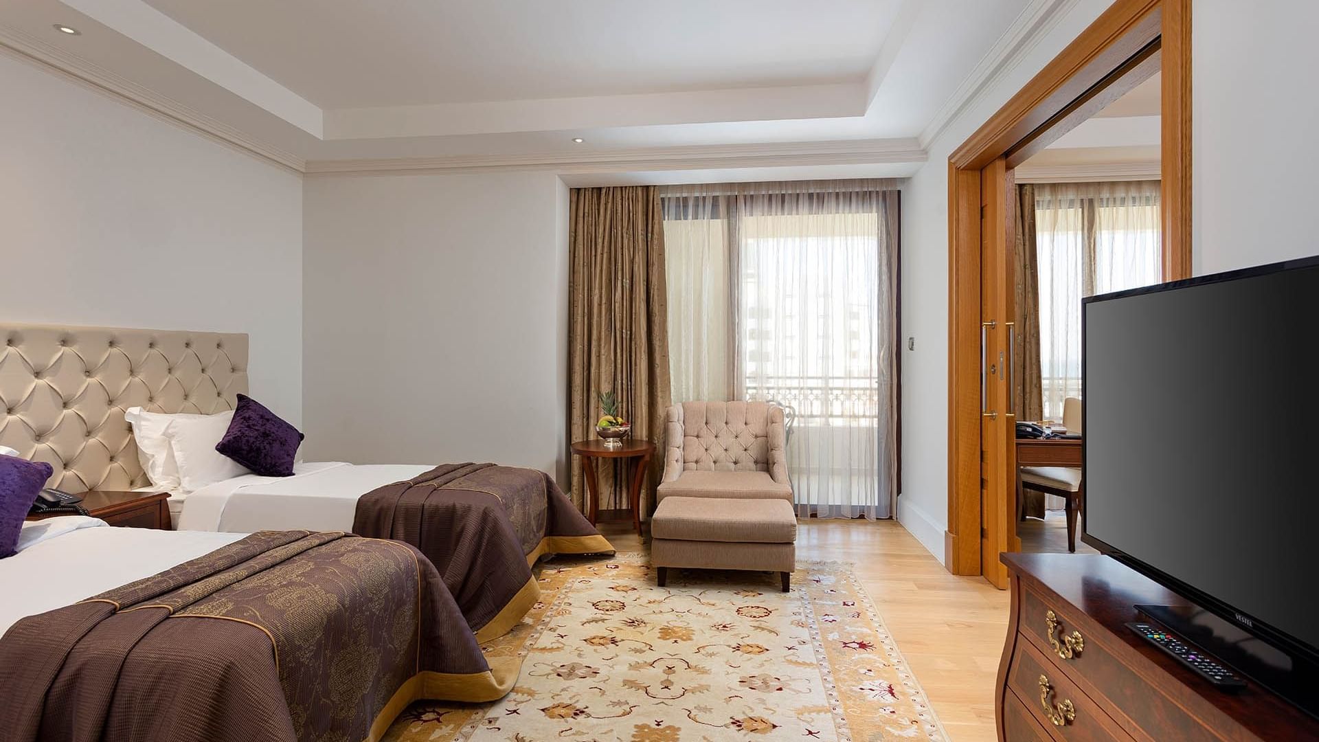 Two comfy beds and lounge in Family Room at Titanic Mardan Palace