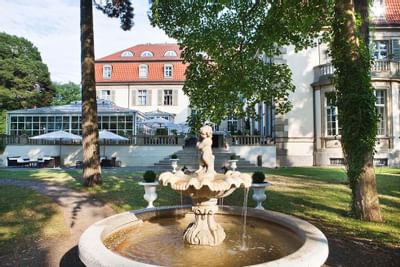 Hotel View with Garden Fountain at Patrick Hellman Schlosshotel