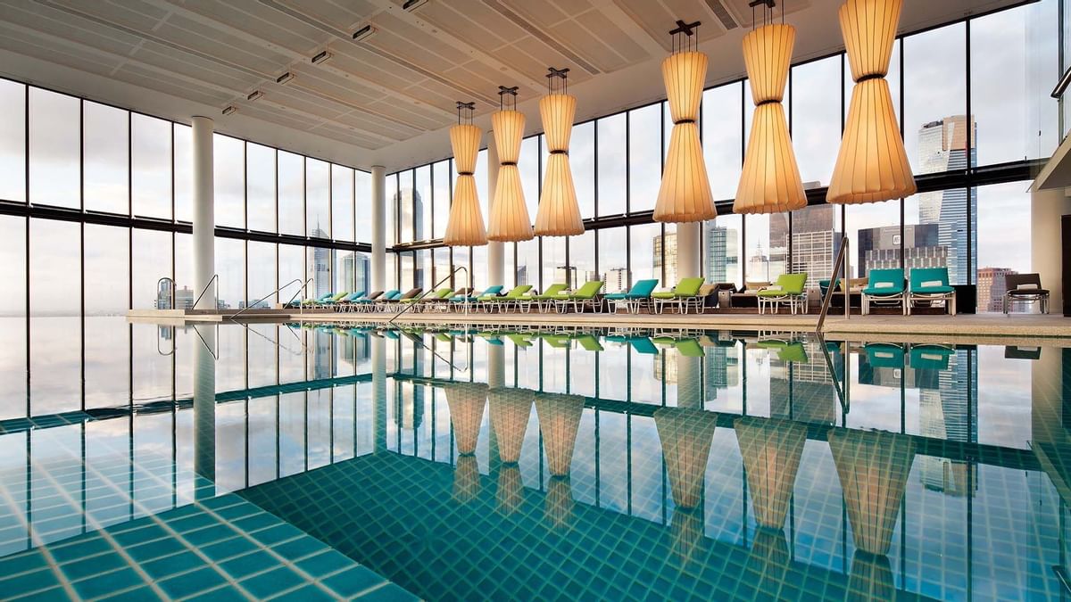 Indoor pool area with lounges at Crown Hotels