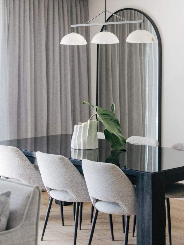 Coastal Two Bedroom Suite at Elysium Manly with a glossy dining table by a ceramic vase, offering cozy Manly accommodation