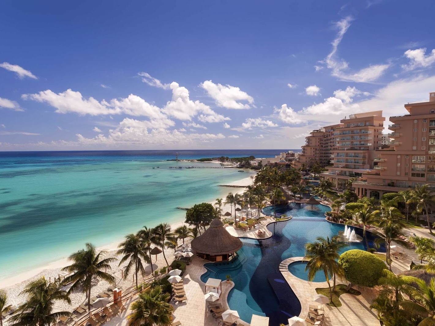 Aerial view of the hotel with pool near the sea in Cancún city