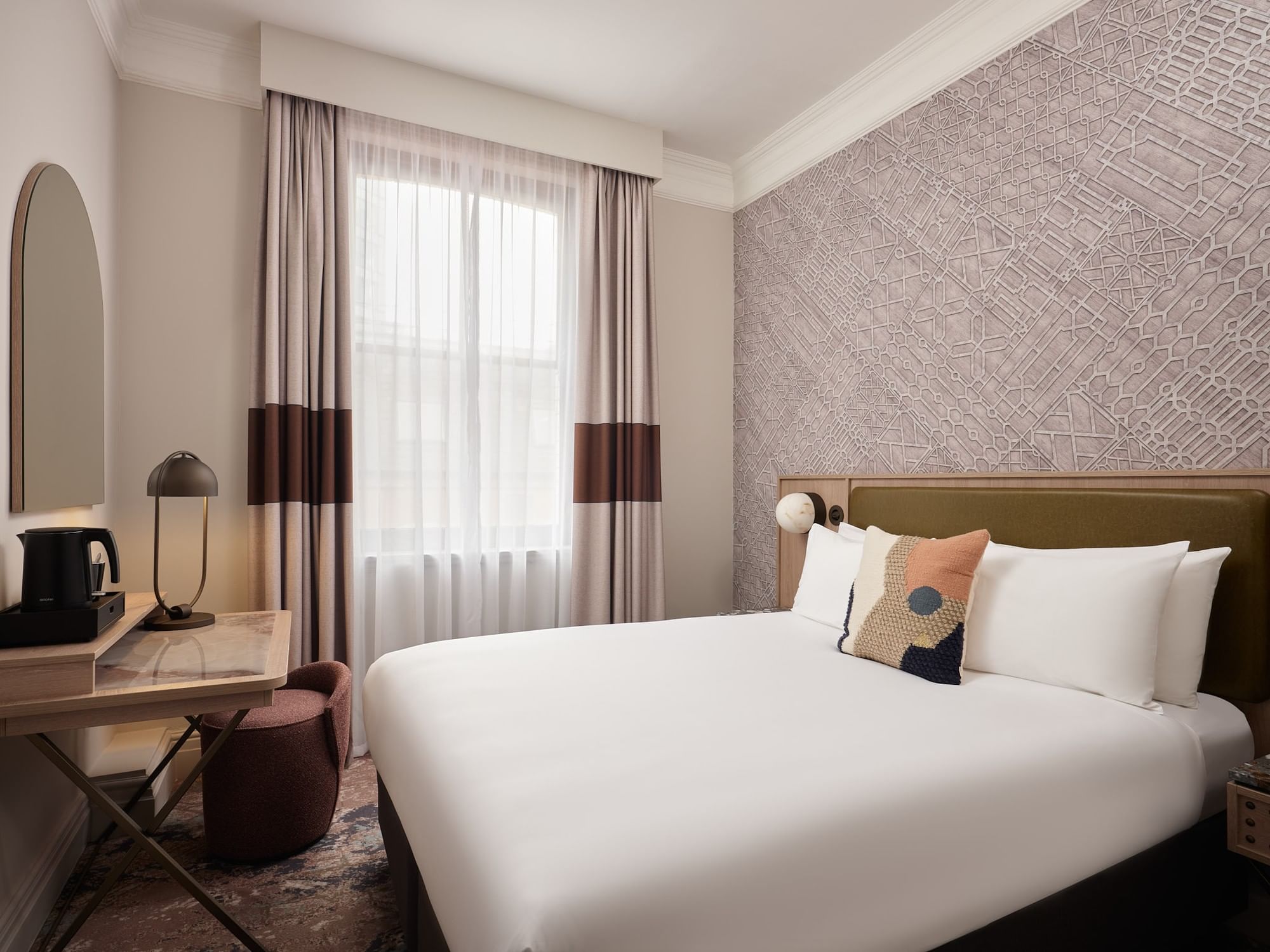 Comfortable king-sized bed and desk area next to a tall window in Standard Double Room at The Met Hotel Leeds, England