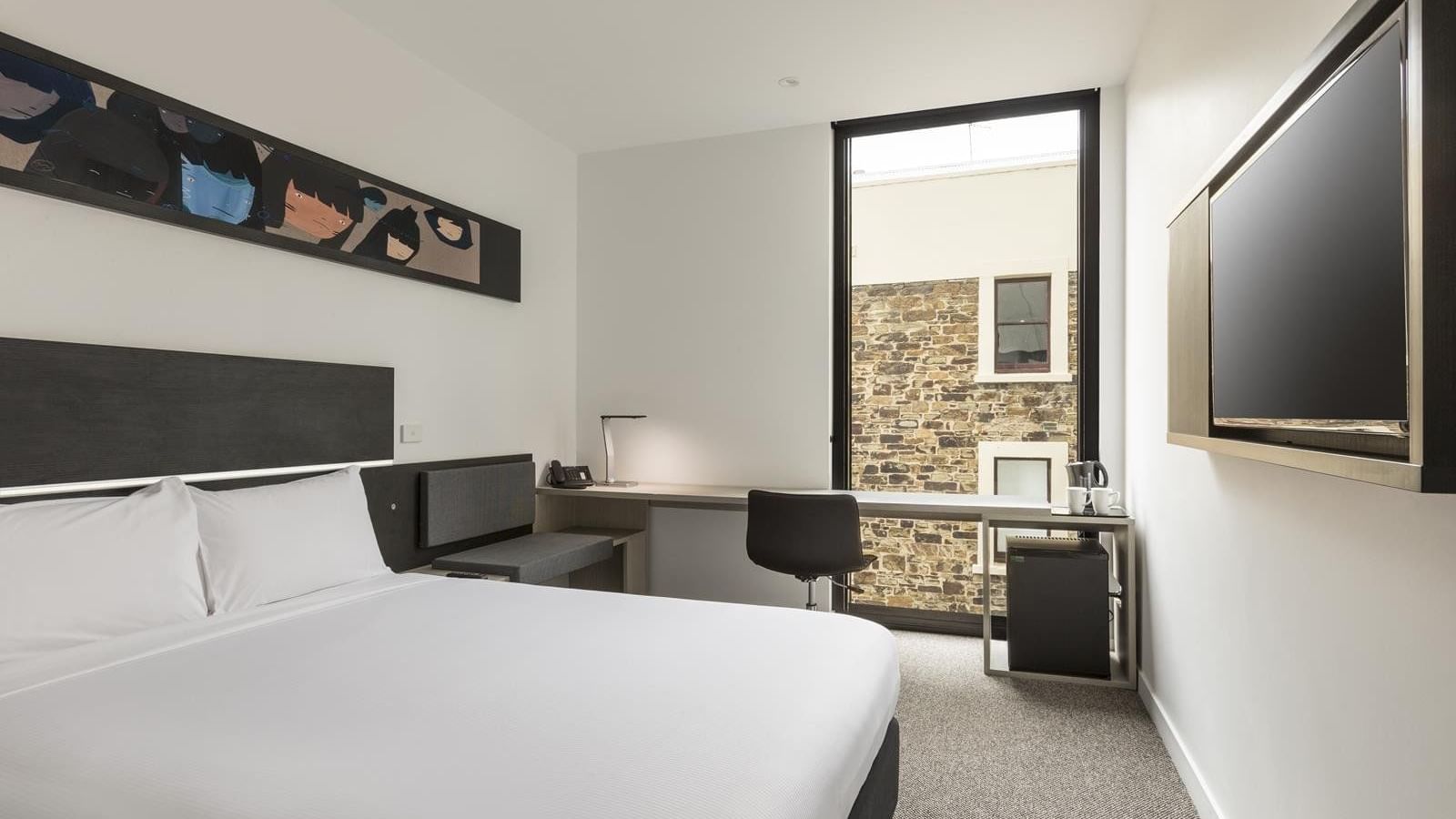 Bed with workspace by the window in Standard Room Two Single Beds at Ibis Adelaide