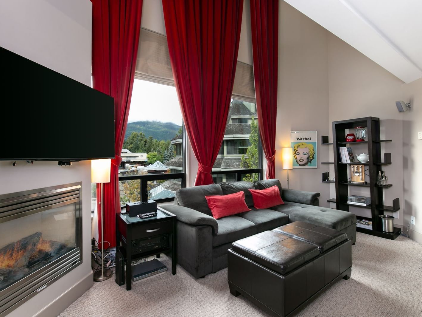 Broad living space in hotel room with kitchenette.