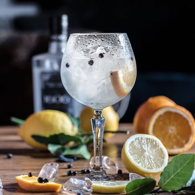 Close-up of a lemon cocktail & lemons at Falkensteiner Hotels