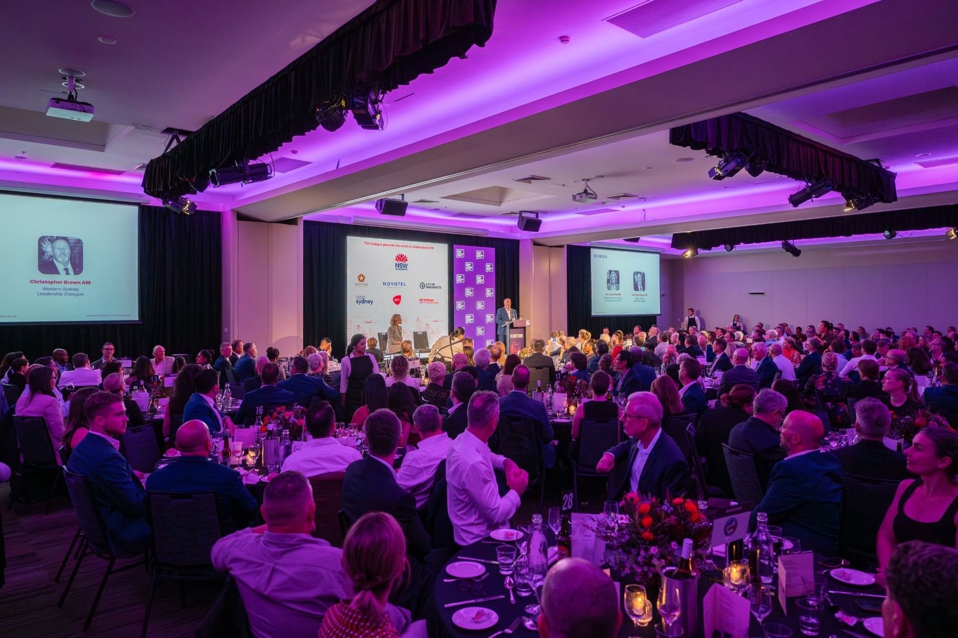 Guests seated at round tables in the Freshwater Room at Novotel Sydney Olympic Park