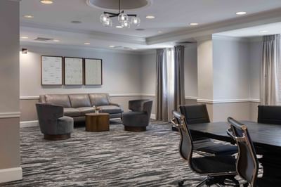 Boardroom set-up & sofa in Gorges Room with carpeted floors at Portland Harbor Hotel