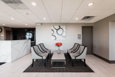 Lobby lounge area with front desk & seating area at Garden Executive Hotel, one of the best hotels in South Plainfield, NJ