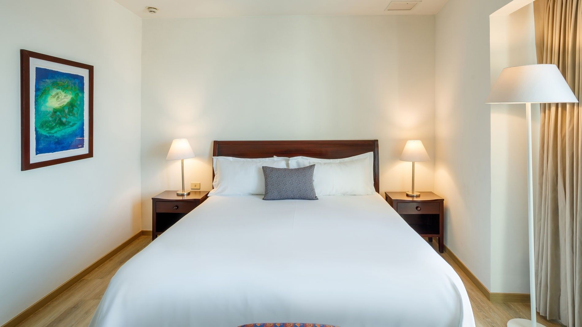 King Junior Suite featuring a large bed with wooden headboard and warm bedside lamps at Camino Real Pachuca