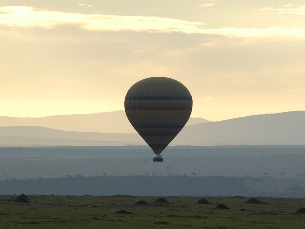 Hot Air Balloon Flying Near Hills At Mara Serena Safari Lodge