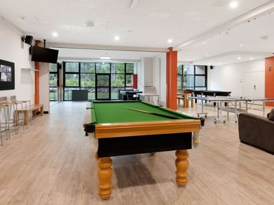 Spacious game room with pool and ping pong tables at La Trobe University – Menzies College.