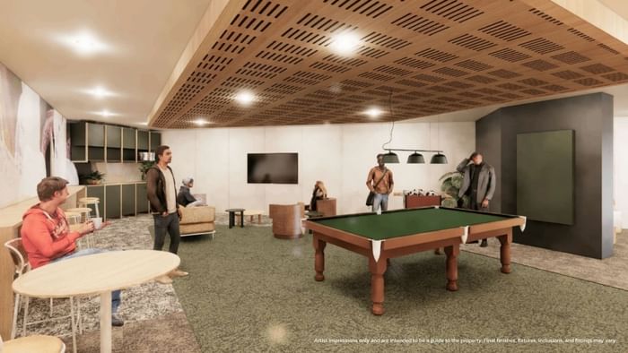 People in a games space with pool table and TV at UniLodge Brisbane City.