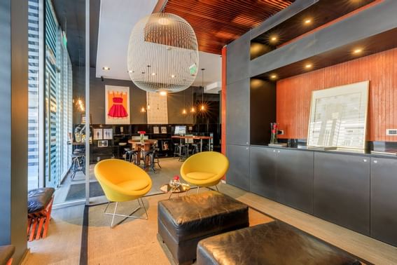 Interior lobby area with sofas, tables & a lamp at Hotel Ismael