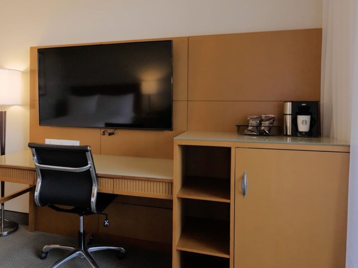 Desk with tv, chair, coffee station, storage