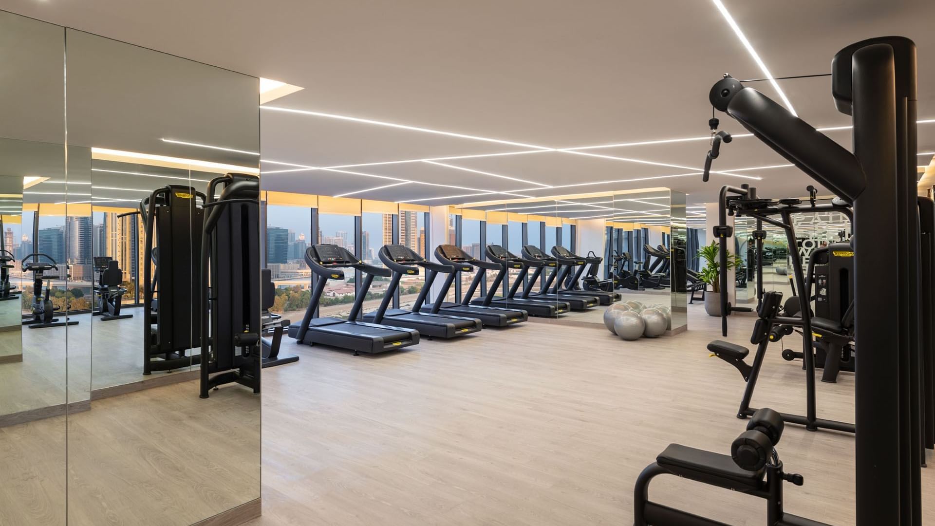 Exercise machines in the Fitness Centre overlooking the city at DAMAC Maison Aykon City Hotel Apartments