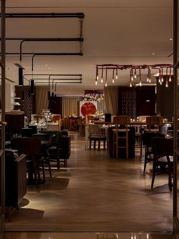 Modern dining room at The May Fair Kitchen at The May Fair Hotel in London, with stylish furnishings and a welcoming atmosphere.