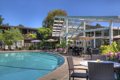 Dining table by the Outdoor Heated Pool at Dinah's Garden Hotel
