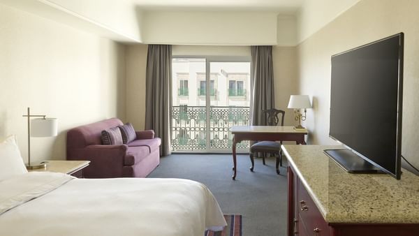 Lounge area and comfy bed in Fiesta Club 1 King bedroom at FA Hotels