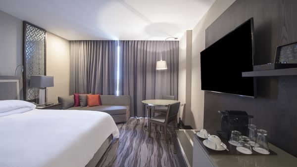 TV & bed in Deluxe King Room at Grand Fiesta Americana