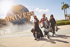 Group of people walking towards the Universal Studios globe near Lake Buena Vista Resort Village & Spa